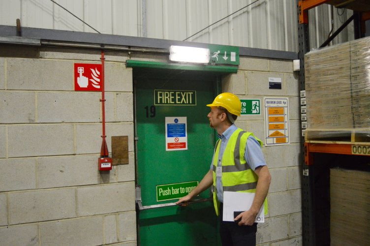 man next to a fire exit